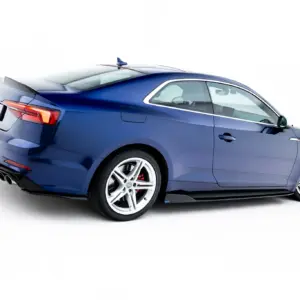 Blue Audi sports coupe photographed from rear-side angle, showing sleek design and dual exhausts