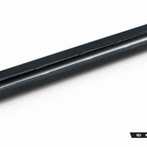 Pair of black car side skirts shown diagonally on a white background with Maxton Design branding visible at the bottom right.