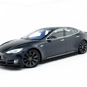 Front three-quarter view of a dark-gray Tesla Model S in a white studio background, showcasing its sleek design.