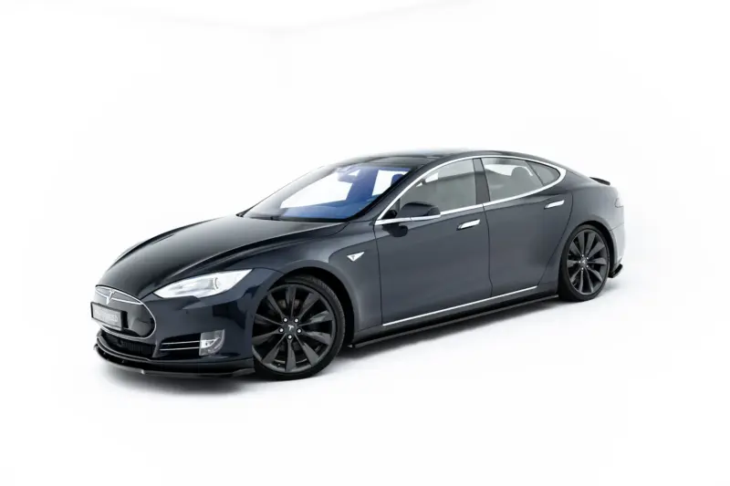 pol_po_Side-Skirts-Diffusers-V-1-Tesla-Model-S-Mk1-23946_3webp - OPSHOLDERS Front three-quarter view of a dark-gray Tesla Model S in a white studio background, showcasing its sleek design.