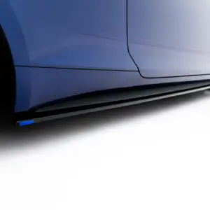 Close-up of a blue car's side panel and alloy wheel, showing the car's sleek body line and wheel rim details
