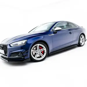 Blue Audi sports coupe photographed from a low front-left angle, showcasing front grille and wheel detail against a white background.