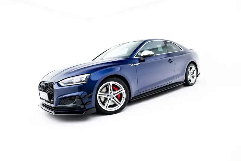Blue Audi sports coupe photographed from a low front-left angle, showcasing front grille and wheel detail against a white background.
