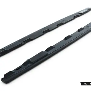 Two dark roof rack crossbars with integral mounting slots, angled diagonally on a white background (Maxton Design).