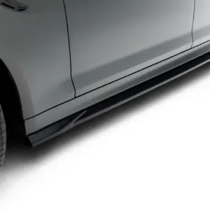Close-up of a gray car's side with a black lower rocker panel and alloy wheel visible at the left edge