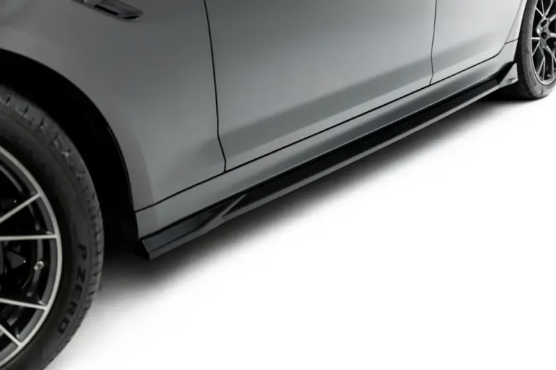 pol_po_Side-Skirts-Diffusers-V-2-BMW-M5-F90-23921_2webp - OPSHOLDERS Close-up of a gray car's side with a black lower rocker panel and alloy wheel visible at the left edge