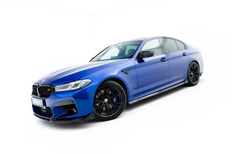 Blue luxury sedan shown from a low front-left angle, highlighting the grille and black alloy wheels.