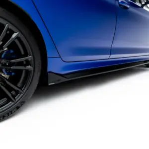 Close-up of a blue sports car showing a large black alloy wheel with braking components visible and the car body in the background.