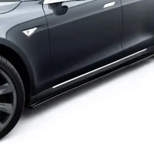 Side view of a dark gray Tesla with a large sporty wheel and bronze/black alloy rim showing the Tesla emblem on the fender.