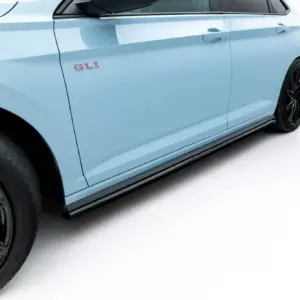 Side view of a light blue car door with a red GLI badge and black alloy wheels visible at the front wheel well.