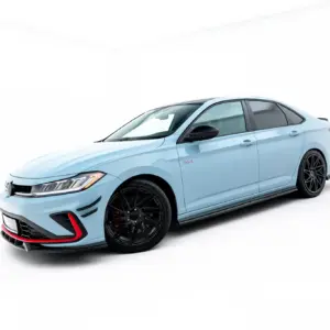 Light blue sports sedan angled in a bright white studio, front-left view with black rims and red accents on the bumper edge.