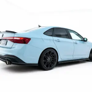 Rear-left three-quarter view of a pale blue sports car with a spoiler, dark wheels, and red tail lights.