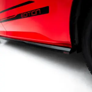 Close-up of a red car door with a black 'Edition' badge and part of a wheel visible, emphasizing the special edition styling