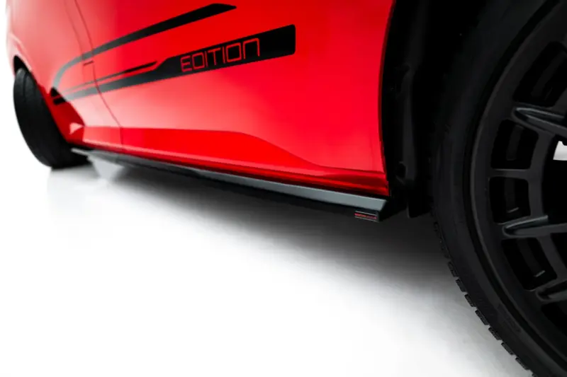 pol_po_Side-Skirts-Diffusers-Volkswagen-Transporter-L1-T7-23939_2webp - OPSHOLDERS Close-up of a red car door with a black 'Edition' badge and part of a wheel visible, emphasizing the special edition styling