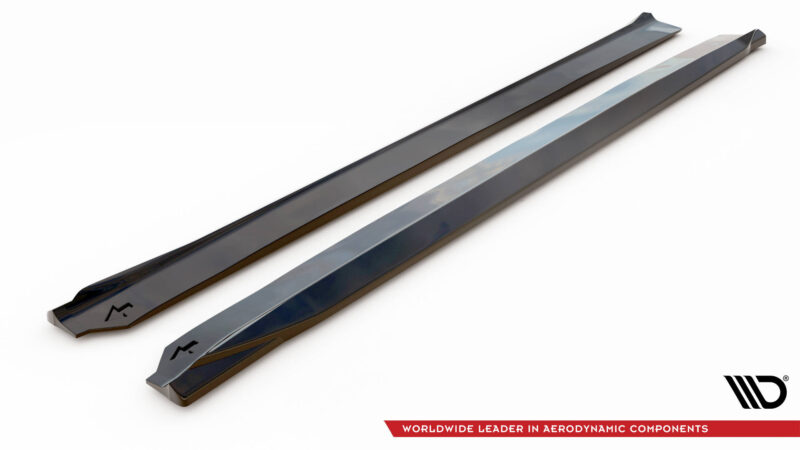 Pair of glossy black aerodynamic side skirts laid diagonally on a white background; MD logo visible in corner.