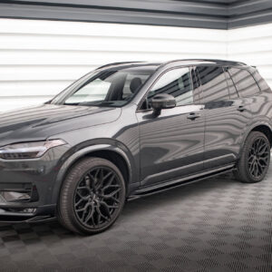 Dark gray SUV shown from the front-right side in a showroom, with glossy finish and large black alloy wheels.