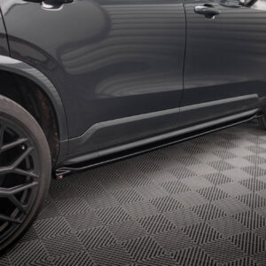 Side view of a dark SUV showing black alloy wheels and lower body trim