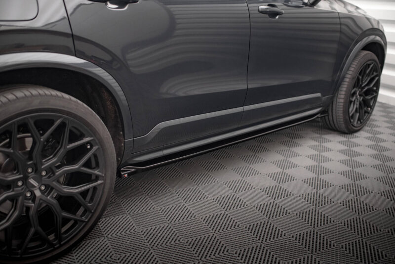 Side view of a dark SUV showing black alloy wheels and lower body trim