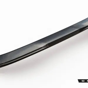 Promotional image of a long, glossy black car aero part (likely a side skirt or spoiler) angled diagonally, with Maxton Design branding visible below.