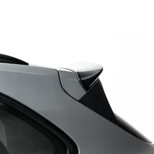 Close-up of a dark gray car rear quarter with smooth roofline and rear window.