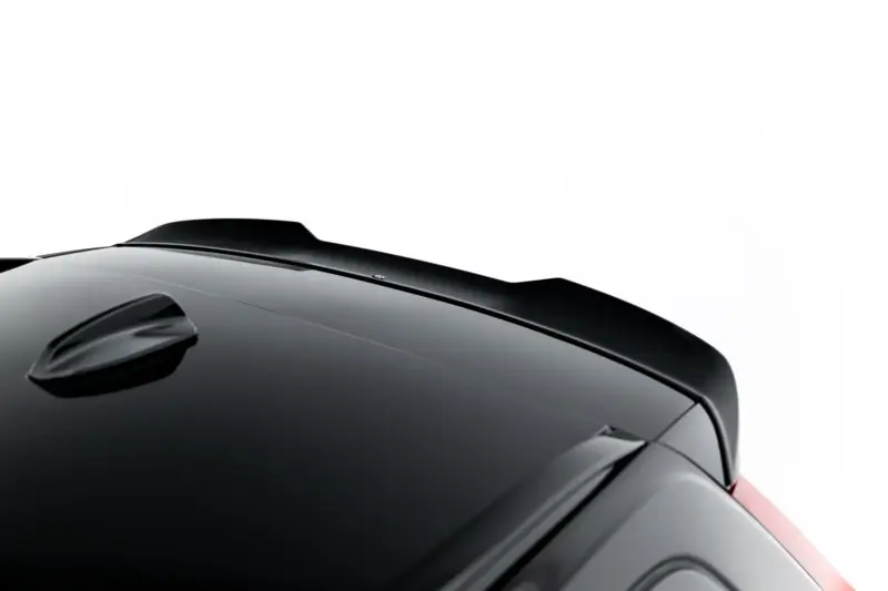Close-up of a sleek black car roof and windshield viewed from above, highlighting smooth curves and glossy finish.