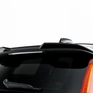 Close-up of the back of a white SUV showing a rear spoiler, curved tail light, and rear wiper on a dark rear window.