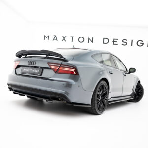 Gray Audi with a rear spoiler in a bright white showroom, Maxton Design branding on the wall behind.