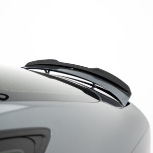 Close-up of a car roof with a glossy black aerodynamic spoiler, viewed from the side against a white background.