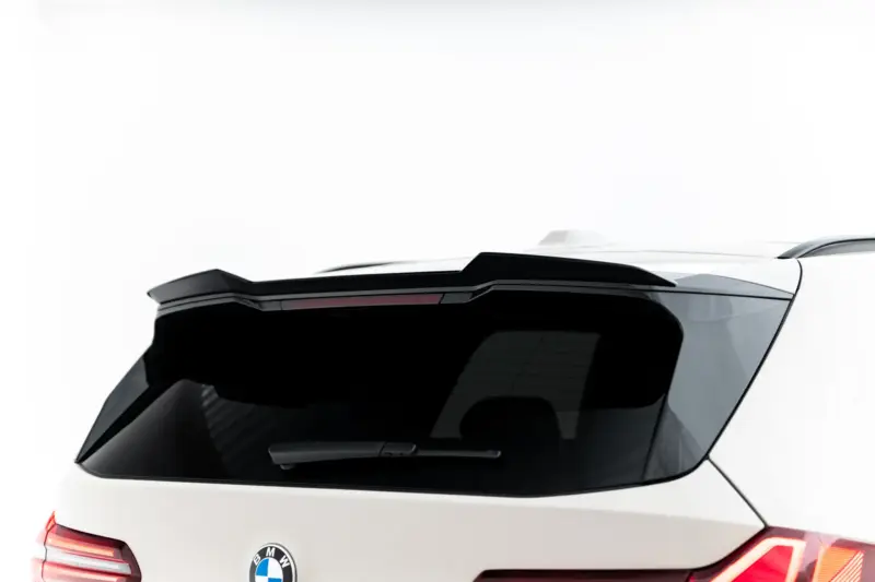 Rear view of a white BMW SUV showing the tailgate, spoiler, and distinctive taillights with the BMW badge visible on the hatch.