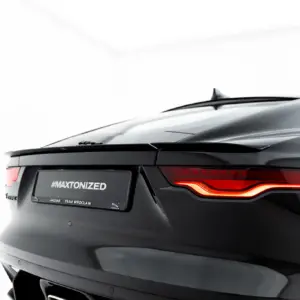 Rear view of a dark Jaguar with illuminated taillights and a visible #MAXTONIZED license plate area.