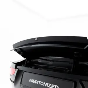 Rear view of a black SUV with its trunk open, displaying the hashtag #MAXTONIZED on the license area and a visible spoiler edge.