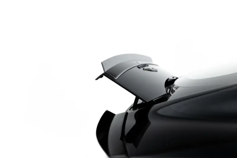 pol_po_Spoiler-Cap-Jaguar-F-Type-X152-Facelift-2-23971_4webp - OPSHOLDERS Close-up of a glossy black car with a rear spoiler against a white background, highlighting the aerodynamic spoiler.