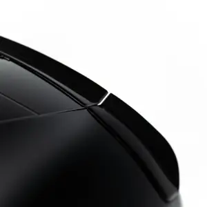 Close-up of a glossy black car hood with a windshield wiper resting along the windshield, diagonally oriented.