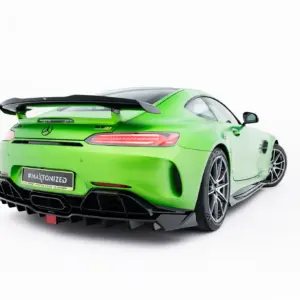 Bright green Mercedes sports car, rear three-quarters view with a large black rear wing, distinctive taillights, and an aggressive diffuser.