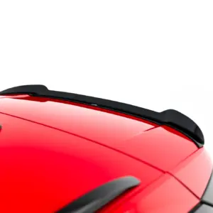 Close-up of a red car roof with black roof rails along the top edge