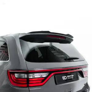 Rear view of a gray SUV showing a black spoiler, red tail lights, and Maxton Design logo on the rear plate.