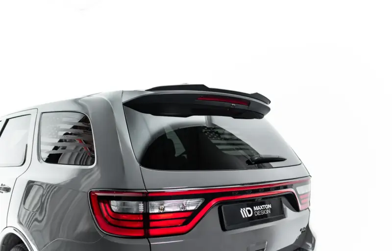 Rear view of a gray SUV showing a black spoiler, red tail lights, and Maxton Design logo on the rear plate.