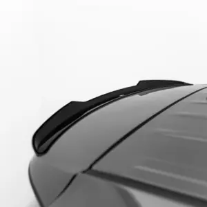 Close-up of a gray car roof with a black shark-fin antenna and roof seam running along the top.