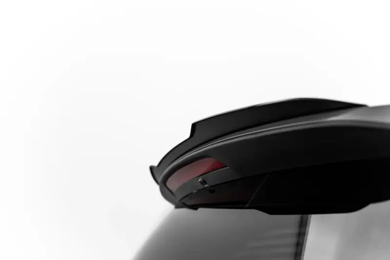 Close-up of a glossy black helmet with a curved visor against a white background.