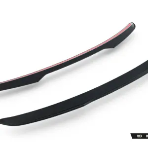 Pair of black curved car aero splitters with a red edge for improved aerodynamics (Maxton Design).
