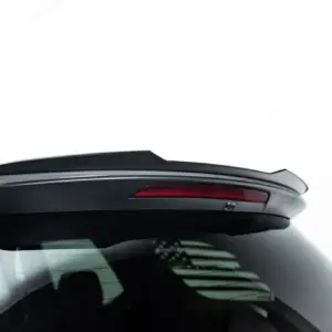 Rear view of a white car showing a black spoiler and red tail light on the hatch area.