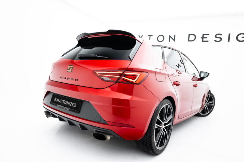 Red hatchback/SUV viewed from rear-left in a studio, showing taillights, rear bumper, and large alloy wheels; hashtag on plate reads “#MAXTONIZED.”