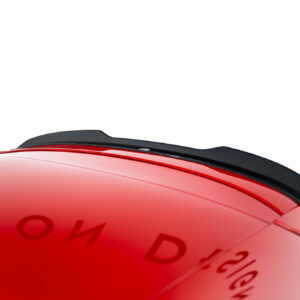 Close-up of a red glossy curved surface with a black trim along the top, against a white background (likely part of a vehicle).