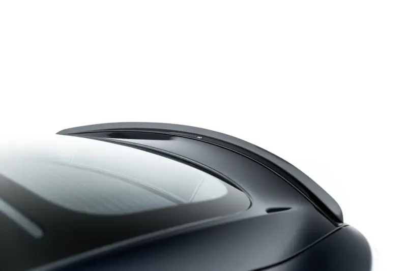 pol_po_Spoiler-Cap-V-2-Tesla-Model-S-Mk1-23949_2webp - OPSHOLDERS Close-up of a dark glossy car roof and windshield curve against a white background, emphasizing sleek styling.