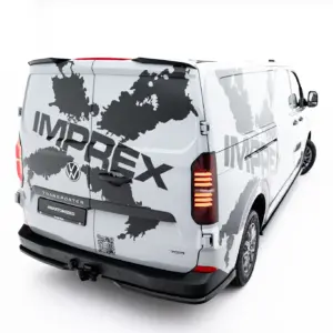 White van with a gray world-map wrap and large bold text along the side and rear, viewed from the back-right corner.