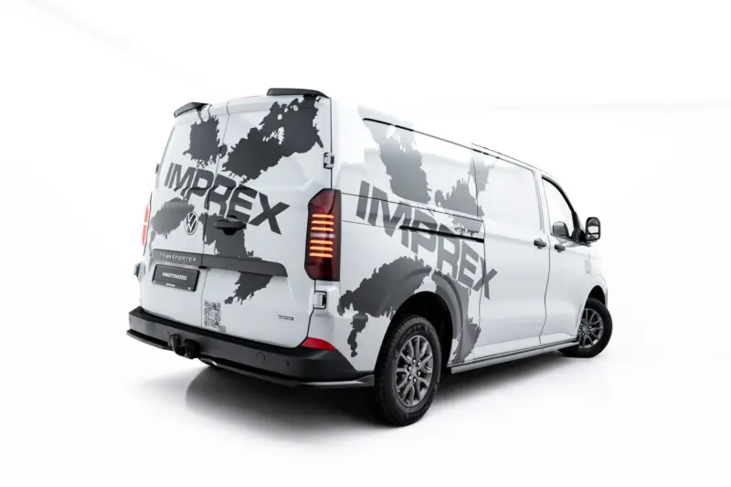 pol_po_Spoiler-Cap-Volkswagen-Transporter-T7-Ford-Transit-Custom-Mk2-23951_5webp - OPSHOLDERS White delivery van with a gray world map graphic wrapping its sides, brand visible down the tailgate.