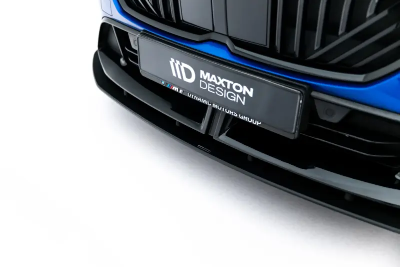 Close-up of a car's front bumper with a Maxton Design branded plate and blue trim accents