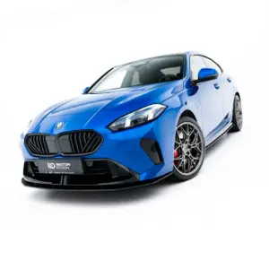 Blue sports car photographed from a low front-left angle against a white studio background, highlighting the aggressive front grille and stylish wheels.