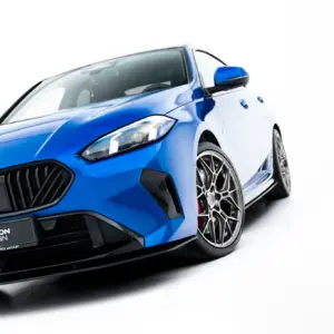 Blue BMW sports car angled to the left, featuring the front grille, headlight, and alloy wheel on a white background.