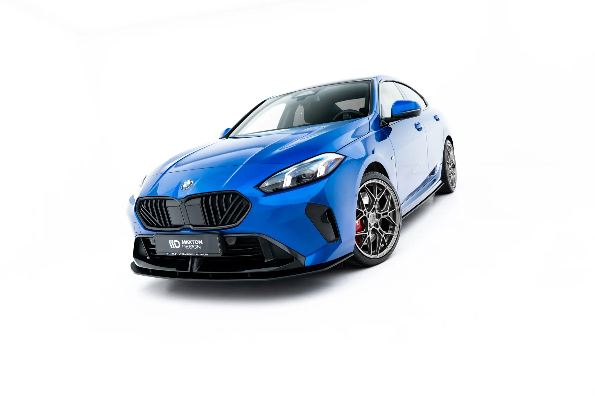 pol_po_Street-Pro-Front-Splitter-BMW-2-M-Pack-M235i-Gran-Coupe-F74-23836_5webp - OPSHOLDERS Blue sporty car shown from a low front-left angle, highlighting the aggressive grille and alloy wheels on a white background.
